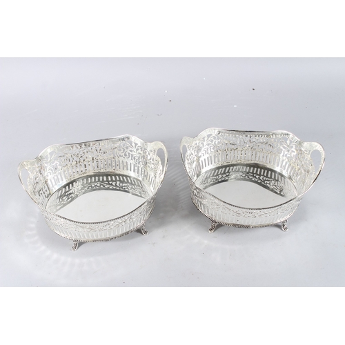 595 - A PAIR OF SILVER PLATE CHERUB SHELL SALTS.