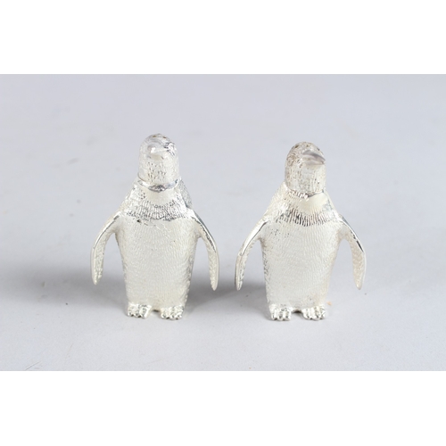 596 - A SMALL PAIR OF SILVER PLATE PENGUIN SALT AND PEPPERS.