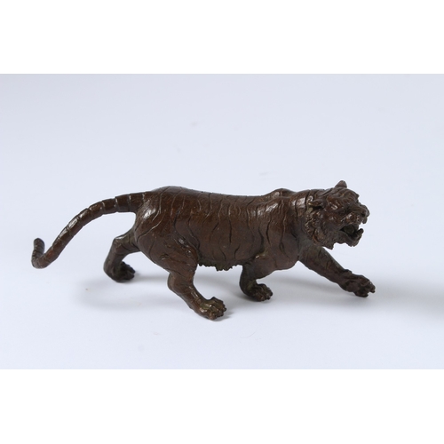 100 - A JAPANESE BRONZE OKIMONO TIGER. 15cms long.