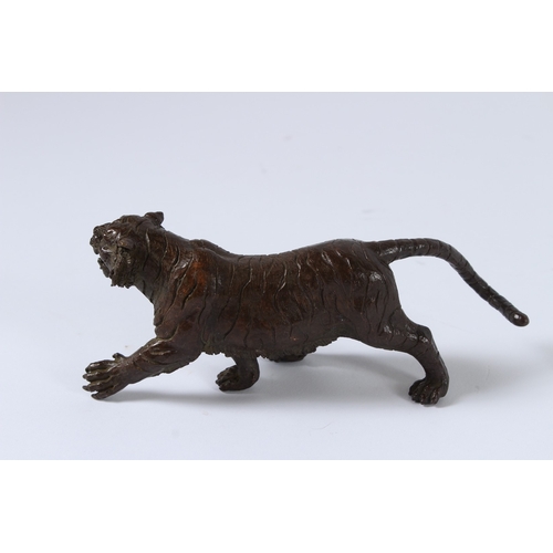 100 - A JAPANESE BRONZE OKIMONO TIGER. 15cms long.