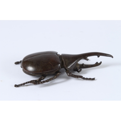 101 - A JAPANESE BRONZE OKIMONO RHINO BEETLE with articulated wing. 10cms high.