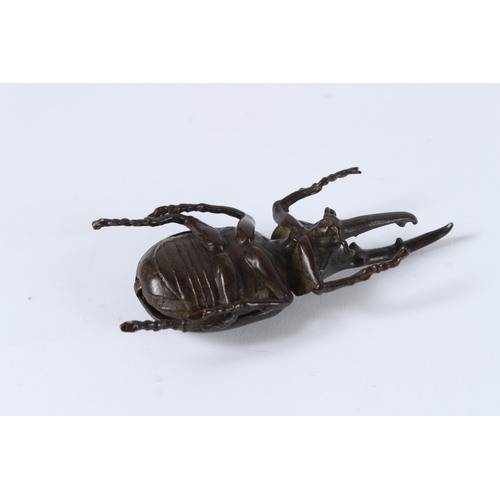 101 - A JAPANESE BRONZE OKIMONO RHINO BEETLE with articulated wing. 10cms high.