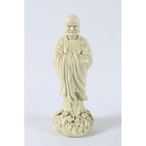 116 - A BLANC-DE-CHINE LUOHAN FIGURE. 32cms high.