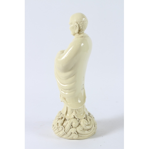 116 - A BLANC-DE-CHINE LUOHAN FIGURE. 32cms high.