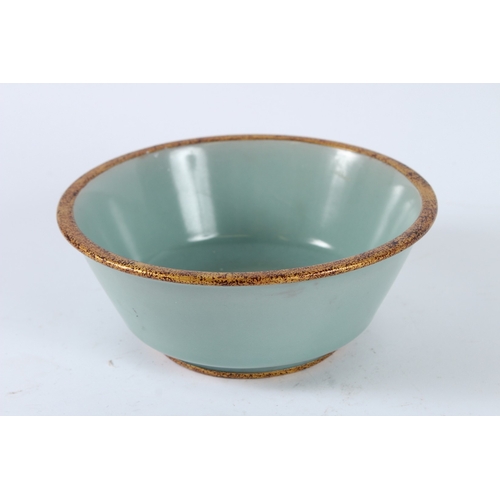 118 - A CHINESE CELADON BOWL with caring character to the base. 19cms diameter.