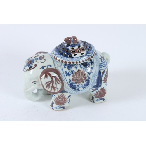 119 - A CHINESE UNDERGLAZE RED, BLUE AND WHITE ELEPHANT INCENSE HOLDER. 17cms high.