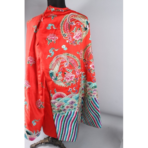 126 - A CHINESE RED GROUND EMBROIDERED  ROBE.