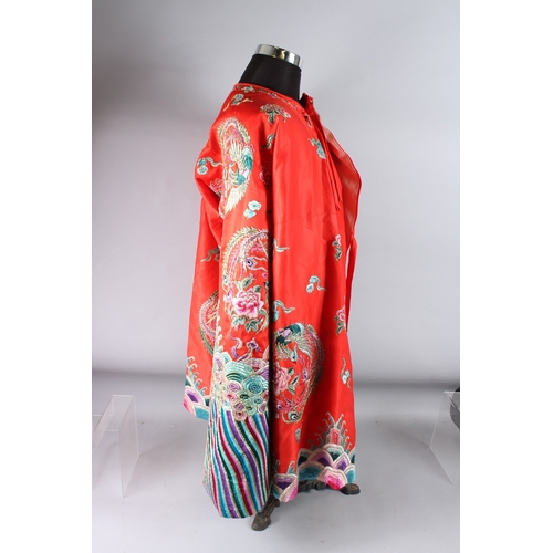 126 - A CHINESE RED GROUND EMBROIDERED  ROBE.
