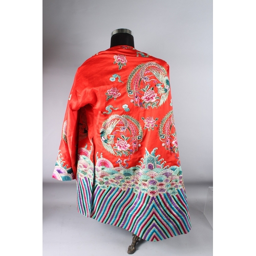 126 - A CHINESE RED GROUND EMBROIDERED  ROBE.