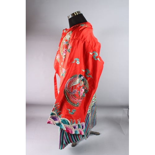 126 - A CHINESE RED GROUND EMBROIDERED  ROBE.