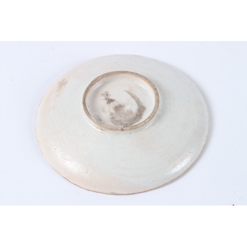 142 - A TURKISH KUTAHYA PLATE with a woman and orange flowers. 14cms diameter.