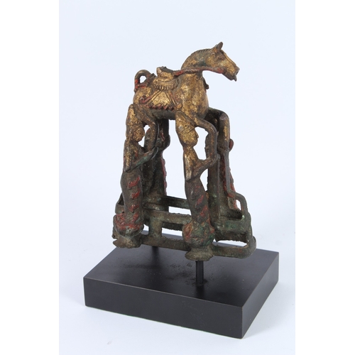 188 - A SOUTH-EAST ASIAN BRONZE STATUE, four men holding a horse.
22cms high.