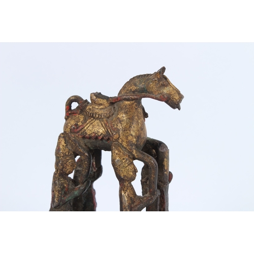 188 - A SOUTH-EAST ASIAN BRONZE STATUE, four men holding a horse.
22cms high.
