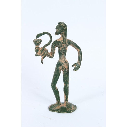 193 - AN ANCIENT BRONZE SCULPTURE, STANDING MAN with green patina. 15cms high.