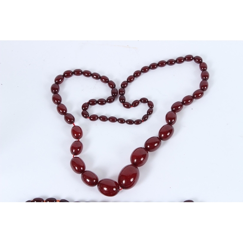 197 - TWO CHERRY AMBER BEAD NECKLACES. 80cms and 40cms long. 95grams.
