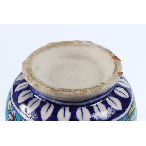 203 - A CERAMIC BOTTLE VASE known as a SURAHI. Iznik pottery. 23cms high.