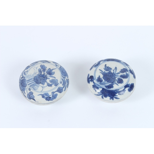 206 - TWO HATCHER CARGO BLUE AND WHITE POTS AND COVERS, decorated with flowers. 9cms diameter.