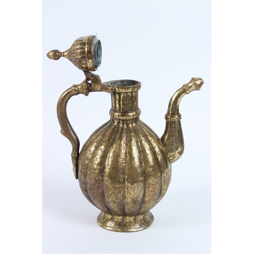 216 - A FINE 18TH - 19TH CENTURY MUGHAL INDIAN ENGRAVED BRASS EWER. 30cms high.