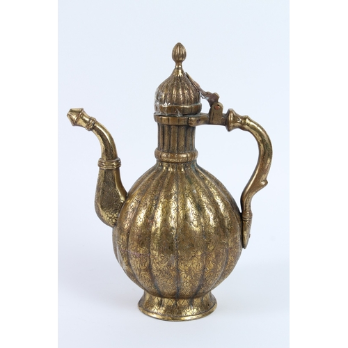 216 - A FINE 18TH - 19TH CENTURY MUGHAL INDIAN ENGRAVED BRASS EWER. 30cms high.