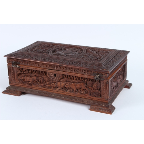 232 - A FINELY CARVED INDIAN SANDALWOOD BOX. 28cms long.