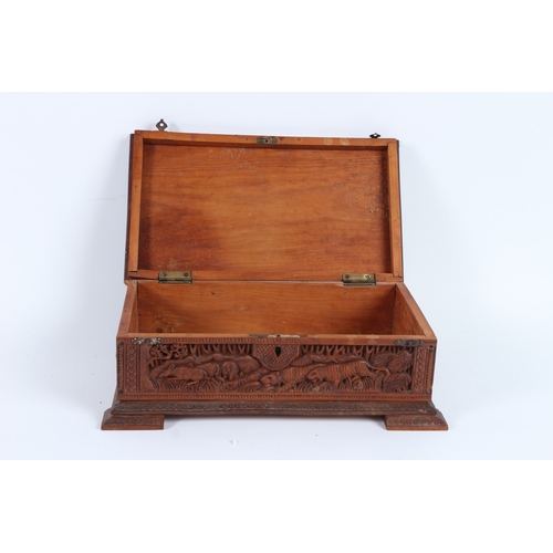 232 - A FINELY CARVED INDIAN SANDALWOOD BOX. 28cms long.