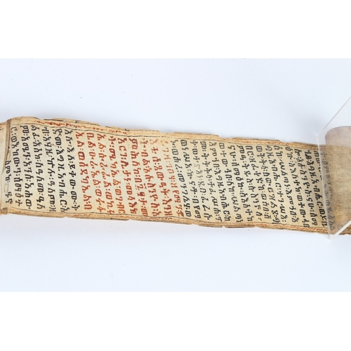 235 - A 19TH CENTURY ETHIOPIAN CALLIGRAPHIC SCROLL. 178cms high x 8cms wide.