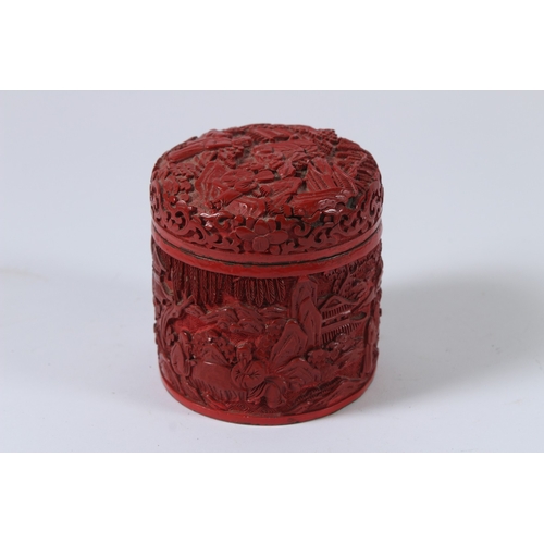 28 - A CHINESE CINNABAR LACQUER CIRCULAR BOX AND COVER. 9cms high.