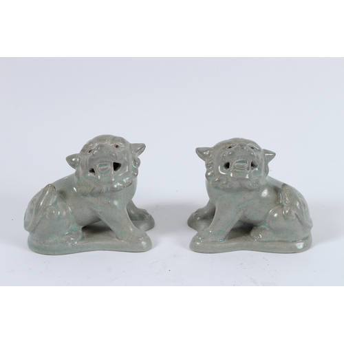 74 - A PAIR OF RU WARE LIONS. 9cms high.