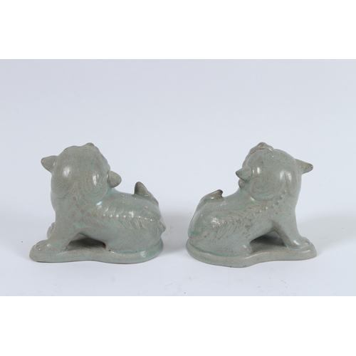 74 - A PAIR OF RU WARE LIONS. 9cms high.