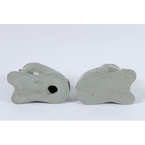 74 - A PAIR OF RU WARE LIONS. 9cms high.