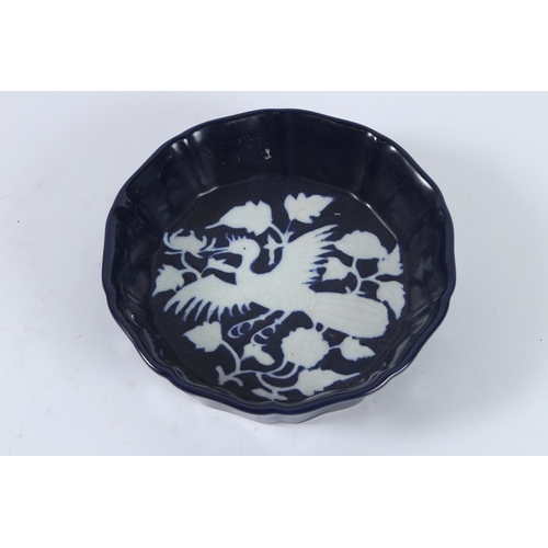 77 - A SACRIFICE BLUE GROUND GLAZE WHITE PHOENIX BOWL. 17cms diameter.