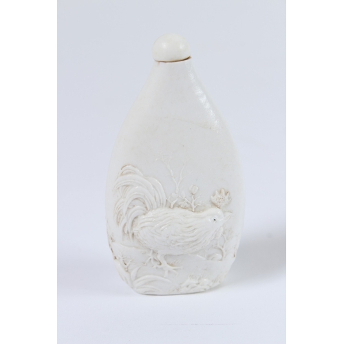 83 - A CHINESE WHITE GLAZE CARVING CHICKEN SNUFF BOTTLE. 9cms.