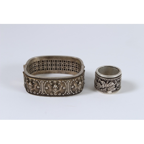 85 - A CHINESE WHITE METAL RING AND BRACELET.