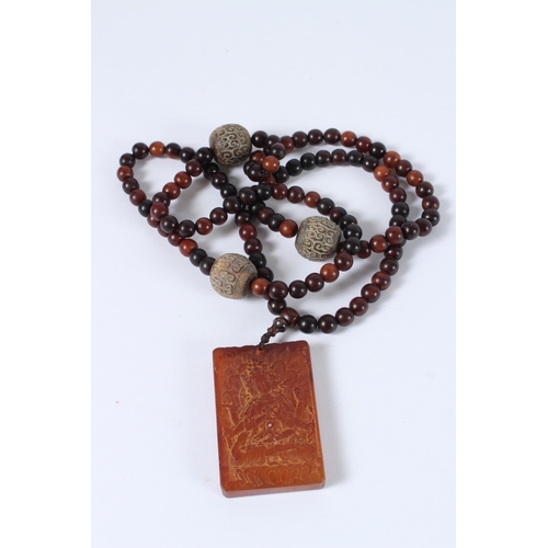 87 - A CHINESE HORN BEAD NECKLACE AND PENDANT.