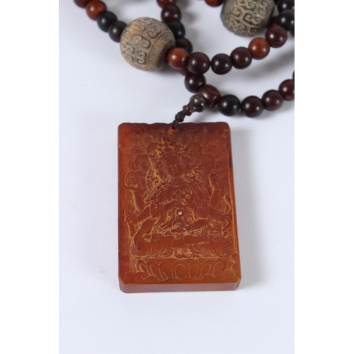 87 - A CHINESE HORN BEAD NECKLACE AND PENDANT.