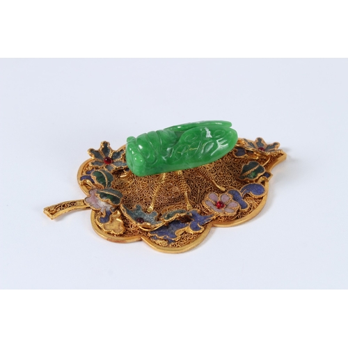 90 - A JADEITE CICADA MOUNTED GILT METAL LEAF. 11cms.