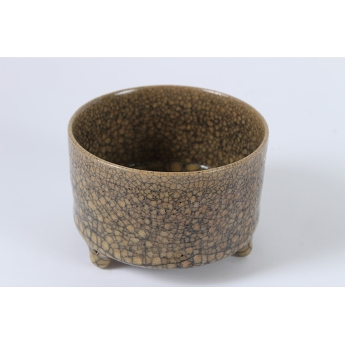 91 - A CHINESE CRACKLE GLAZED TRIPOD BURNER. 11cms diameter.
