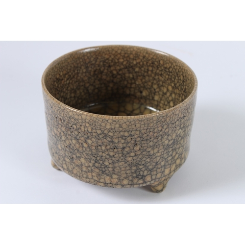 91 - A CHINESE CRACKLE GLAZED TRIPOD BURNER. 11cms diameter.