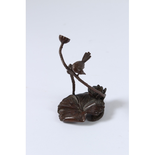 99 - A JAPANESE BRONZE OKIMONO BIRD AND LOTUS. 8cms high.