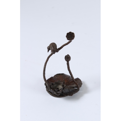 99 - A JAPANESE BRONZE OKIMONO BIRD AND LOTUS. 8cms high.