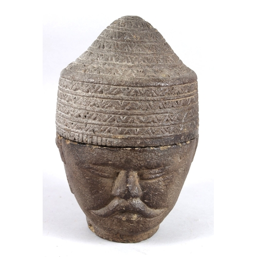 209 - A SOUTH EAST ASIA CARVED STONE HEAD the hat lifts off to reveal a storage jar. 26cms high.