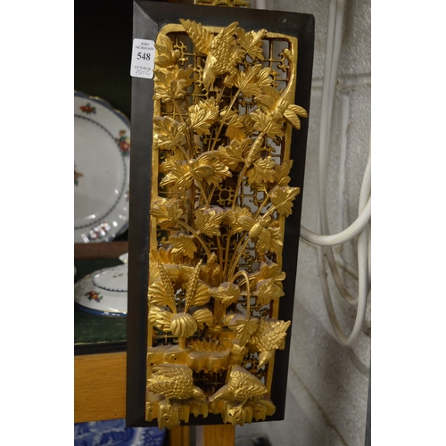 548 - A pair of Chinese carved and pierced wooden plaques with gilded decoration.