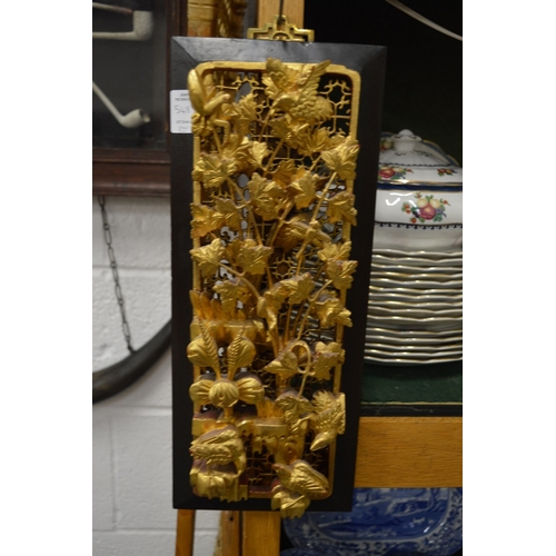 548 - A pair of Chinese carved and pierced wooden plaques with gilded decoration.