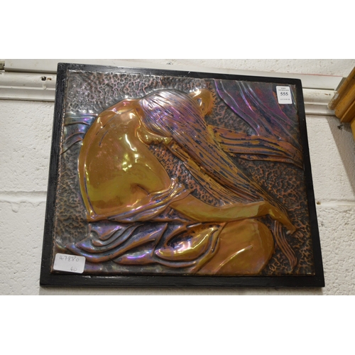 555 - An embossed metal plaque depicting a seated female figure.