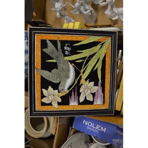 581 - A group of tile pictures, mostly framed and glazed.