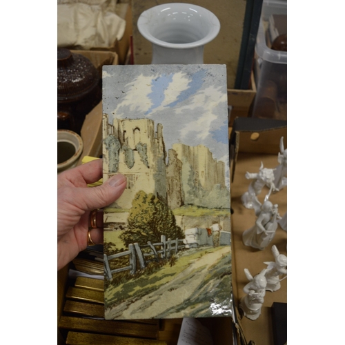 581 - A group of tile pictures, mostly framed and glazed.