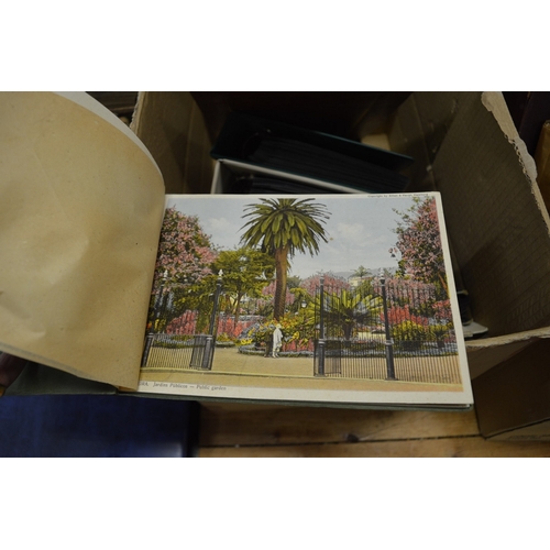 587 - A quantity of postcard albums and contents together with loose postcards.