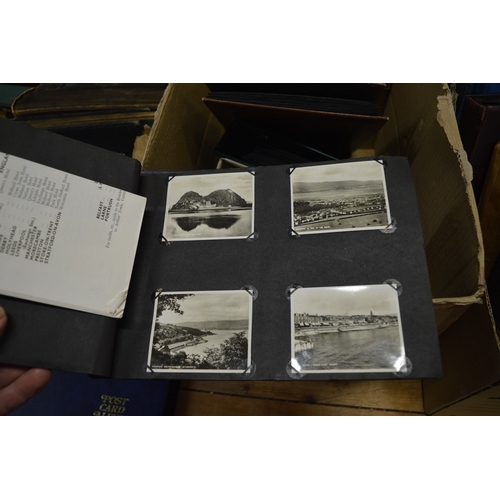 587 - A quantity of postcard albums and contents together with loose postcards.