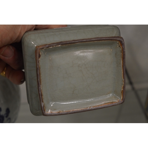 599 - A Chinese celadon glazed square shaped vase with ribbed body.