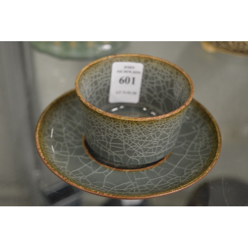 601 - A small Chinese crackle glazed tea bowl and stand.
